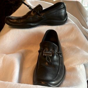PRADA brand black loafers.